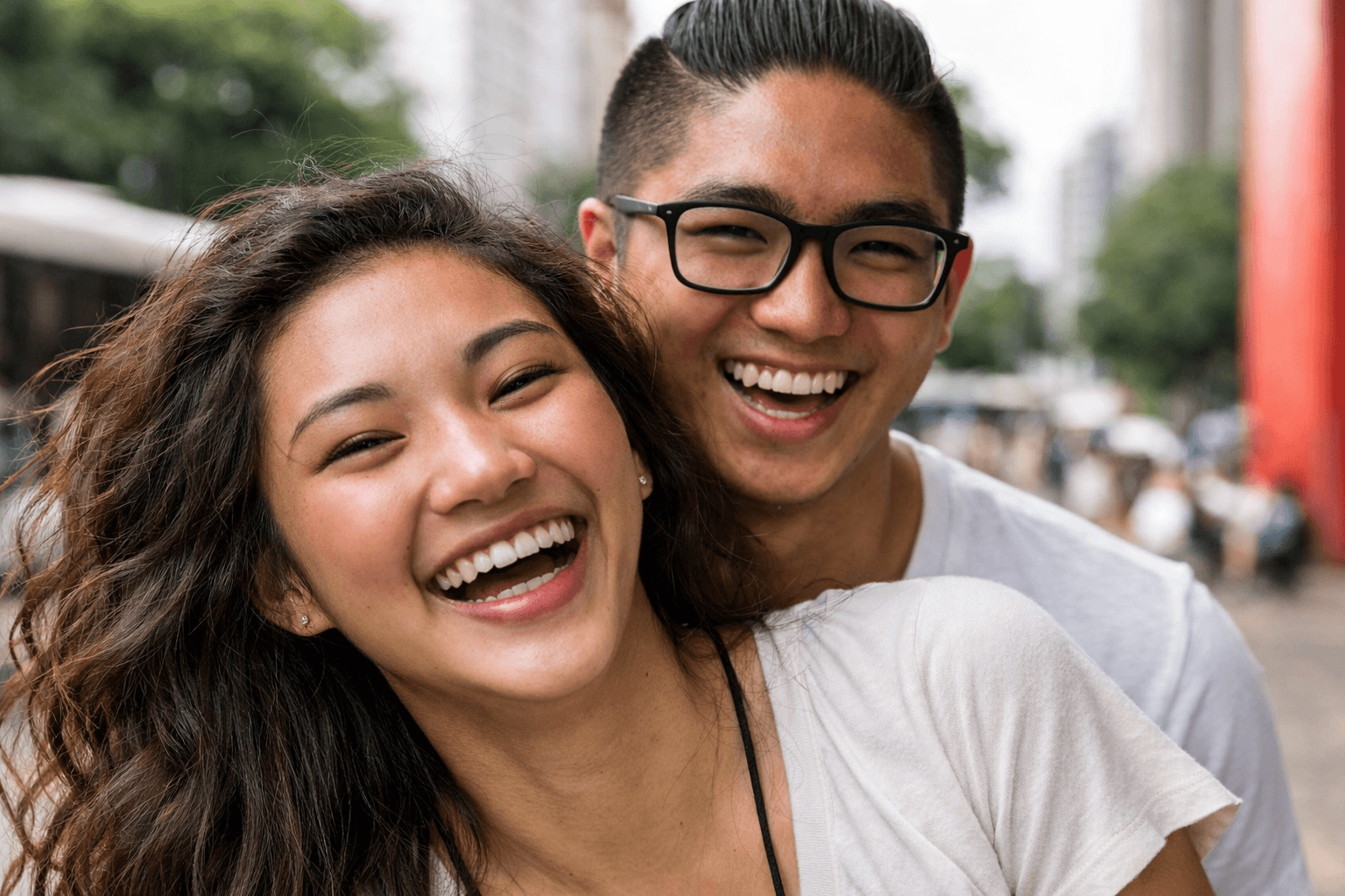 Two smiling adults outdoors